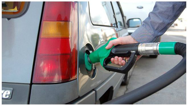 A car is being refilled with petrol, in Kathmandu