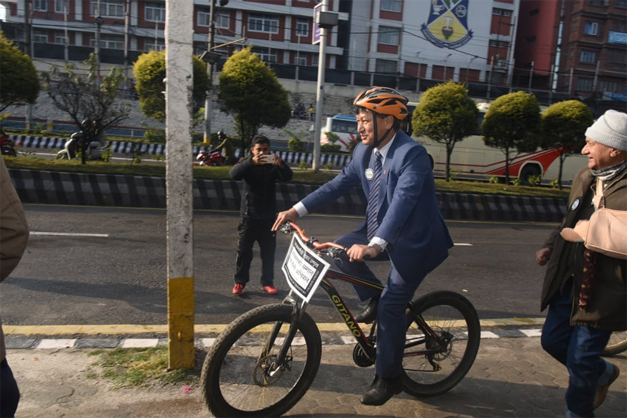 Kathmandu Mayor Bidya Sundar Shakya rides a bicycle for a photograph in 2019.