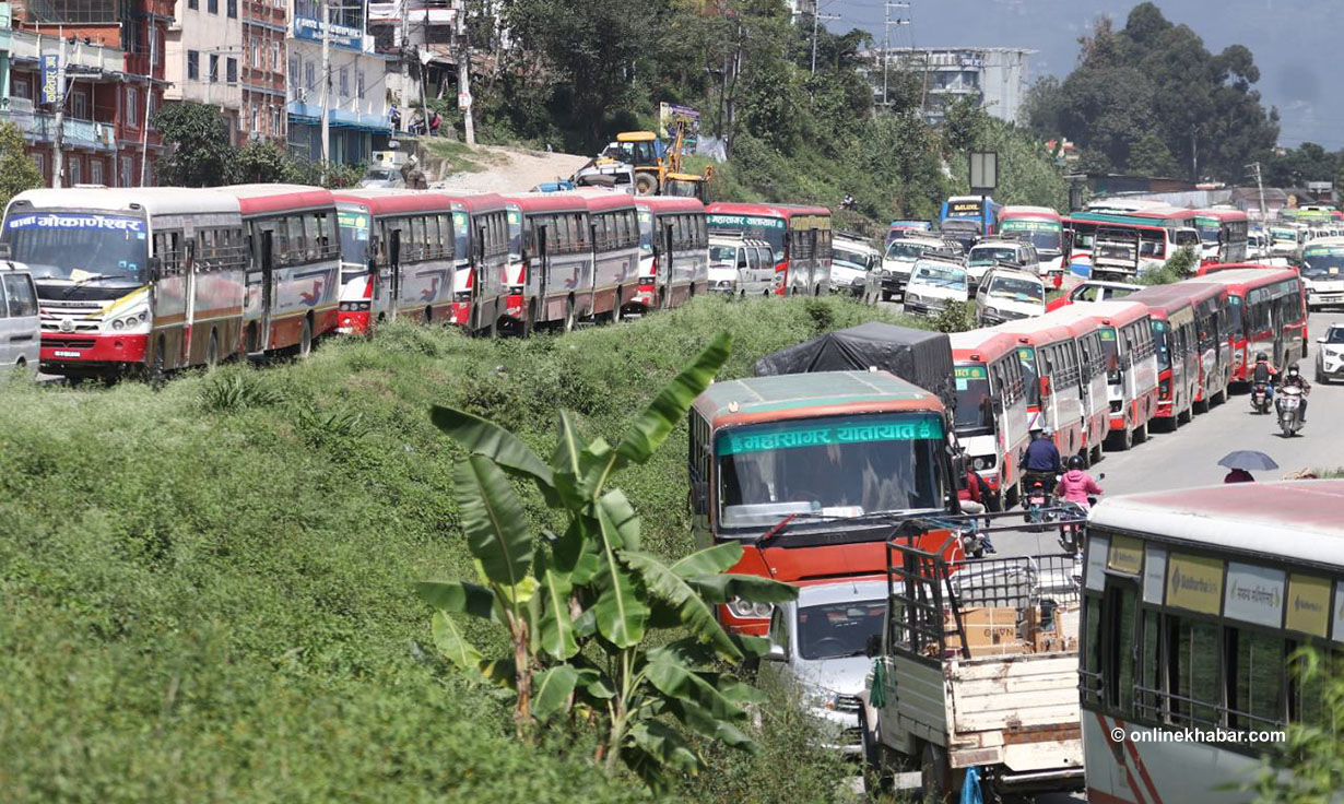 Kathmandu public transport operators park their buses on the roadside as they launch a strike, in Kathmandu, on Monday, October 4, 2021