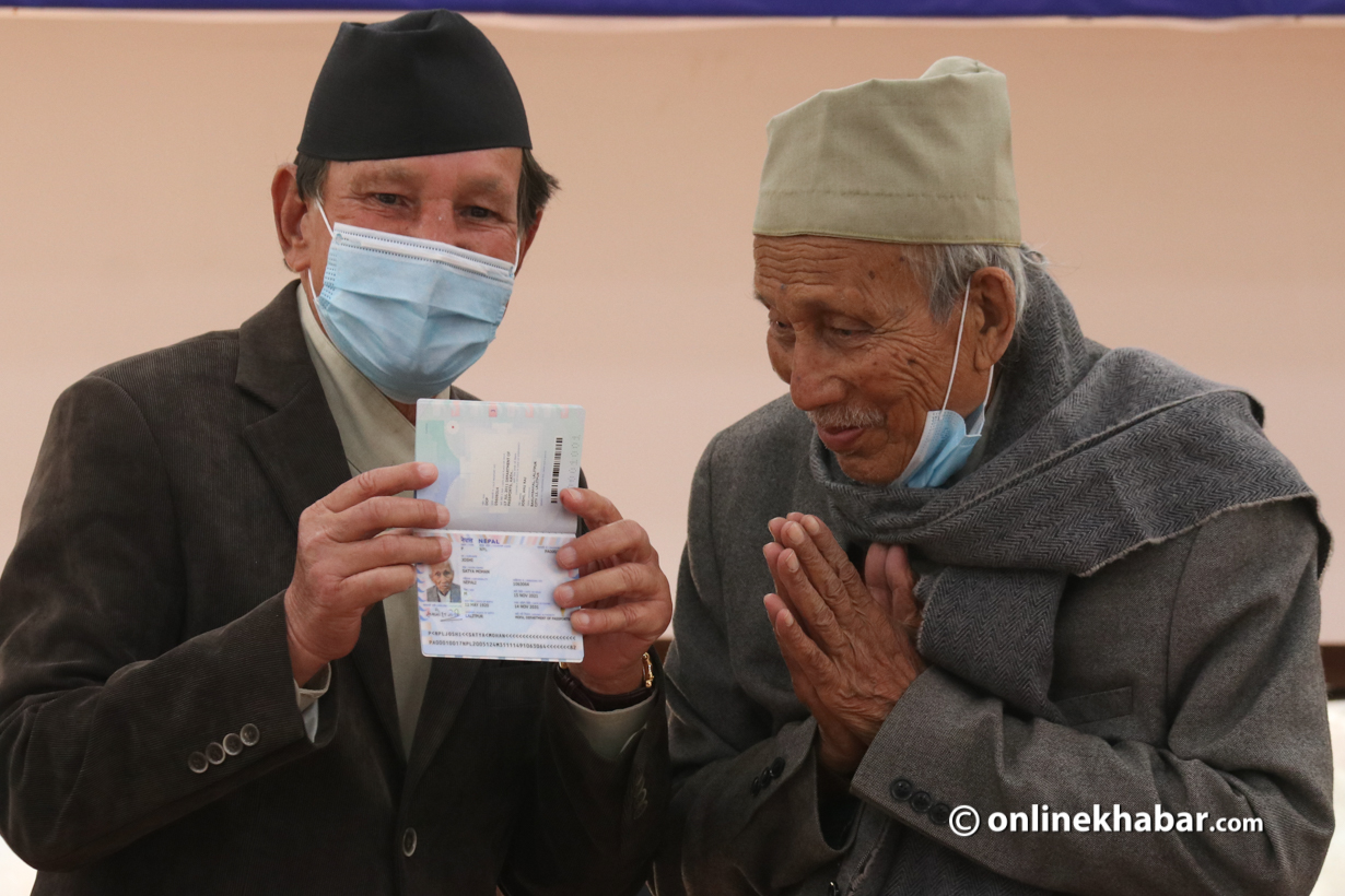 Foreign Minister Narayan Khadka handing over the first e-passport to Satya Mohan Joshi.