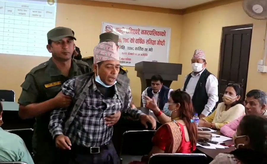 Govinda Bahadur Bhandari, the chairman of Pathari Shanishchare-4, is removed from the municipal meeting, in Morang, on Monday, November 15, 2021.