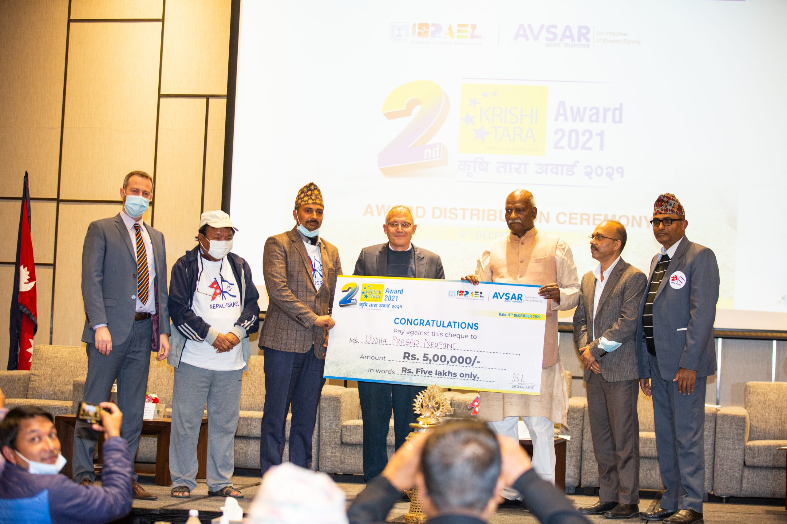 Agriculture Minister Mahindra Raya Yadav and Israeli Ambassador to Nepal Hanan Goder hand over Rs 500,000 in a prize to Dhading-based farmer Uddha Prasad Neupane, in Kathmandu, on Thursday, December 9, 2021. Photo: Israeli Embassy in Kathmandu