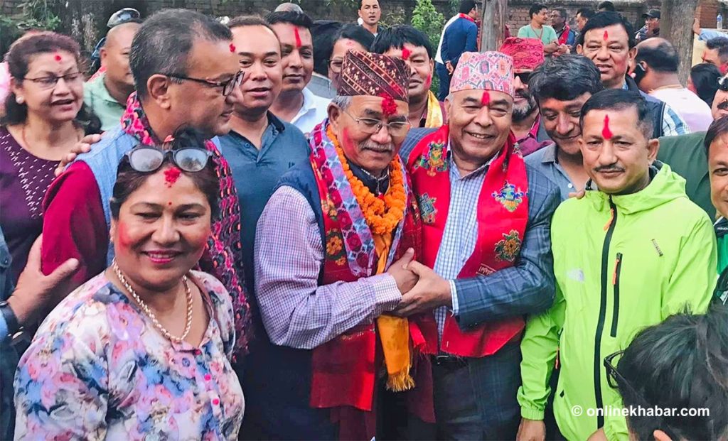 CPN-UML's mayoral candidate Hari Krishna Byanjankar congratulates Nepali Congress Chiri Babu Maharjan on winning the Lalitpur mayoral election, on Tuesday, May 24, 2022.