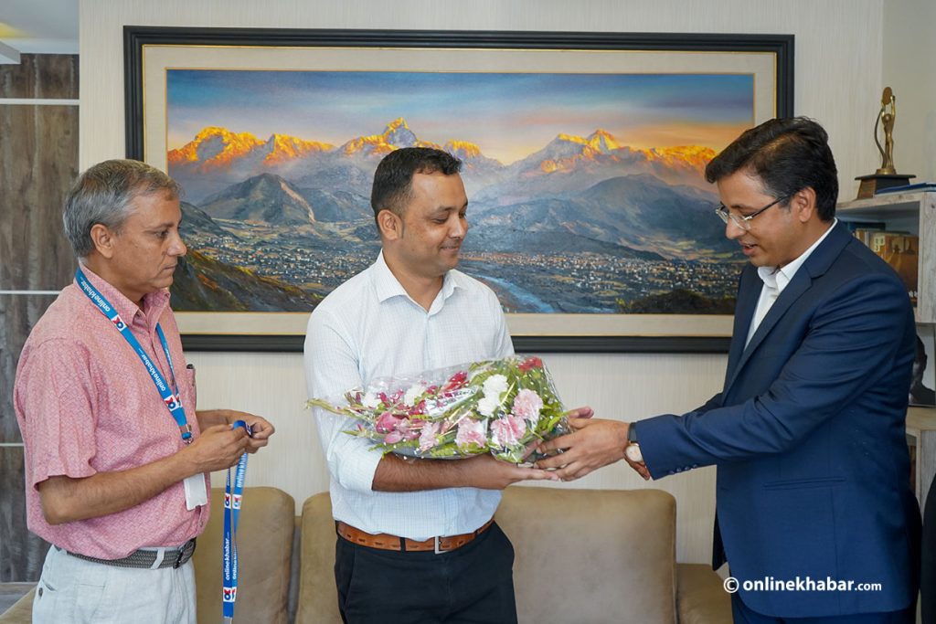 Onlinekhabar chairman Dharma Raj Bhusal (r) and editor-in-chief Shiva Gaunle welcome Basanta Basnet as the news portal's editor, in Kathmandu, on Sunday, July 17, 2022. Photo: Shankar Giri