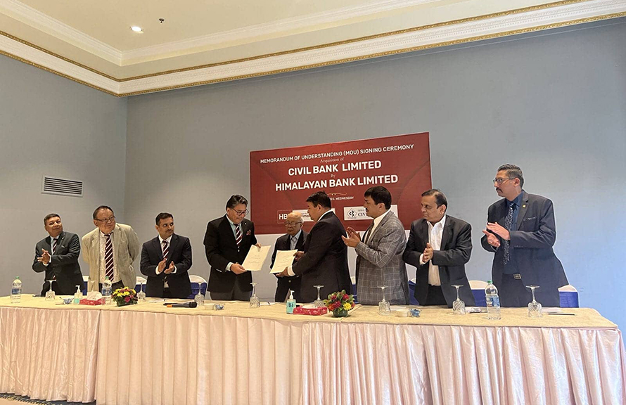 Officials of Himalayan Bank and Civil Bank sign an acquisition deal, in Kathmandu on Wednesday, July 13, 2022.