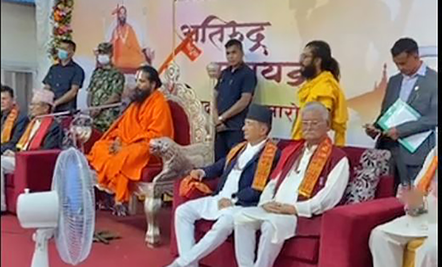 Rape-accused religious leader Krishna Giri aka Siddhababa is flanked by ministers Gyanendra Bahadur Karki and Sher Bahadur Kunwar, in Kathmandu, on Monday, July 18, 2022.